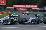 (L to R): Lewis Hamilton (GBR) Mercedes AMG F1 W05 and Nico Rosberg (GER) Mercedes AMG F1 W05 battle at Les Coombes on lap 2. Rosberg damaged his front wing and punctured the left rear wheel of Hamilton's car in the process.